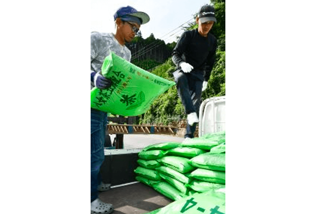 生産者のもとへ届けるため、肥料を積み込む青年部員ら